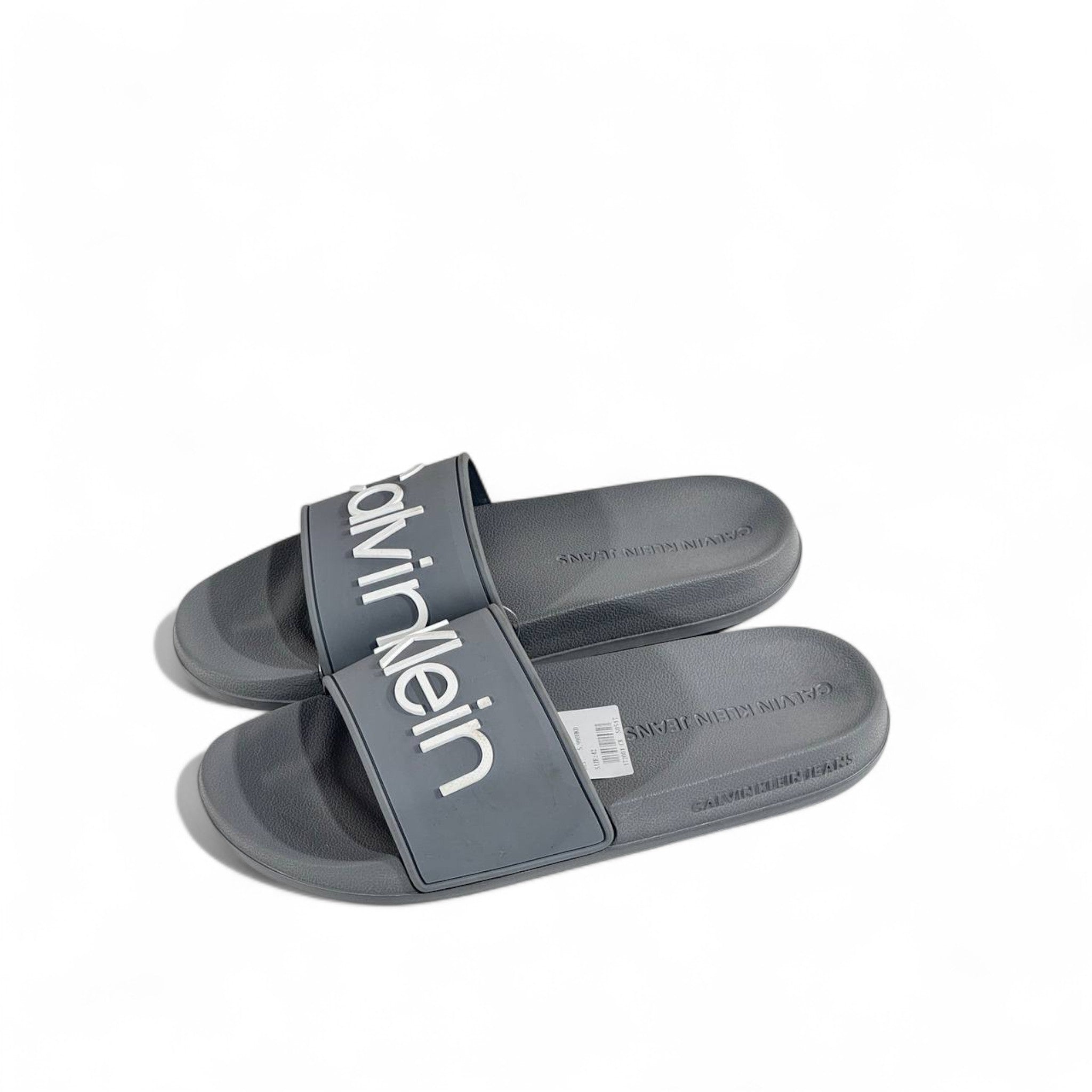 ⚪ Calvin Klein Grey Slides – Oversized White Logo Slippers