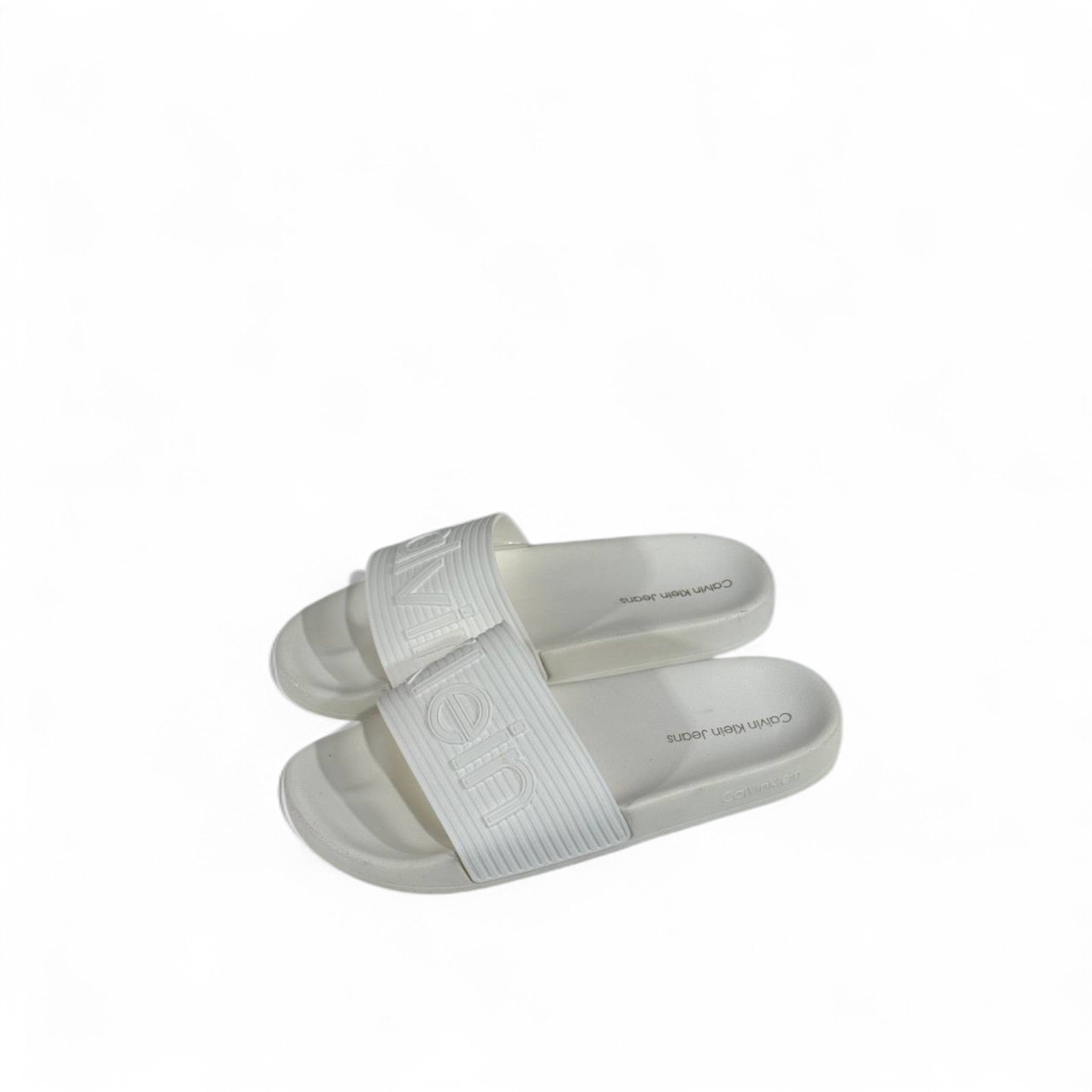 🤍 Calvin Klein All-White Slides – Embossed Logo Luxe Slippers