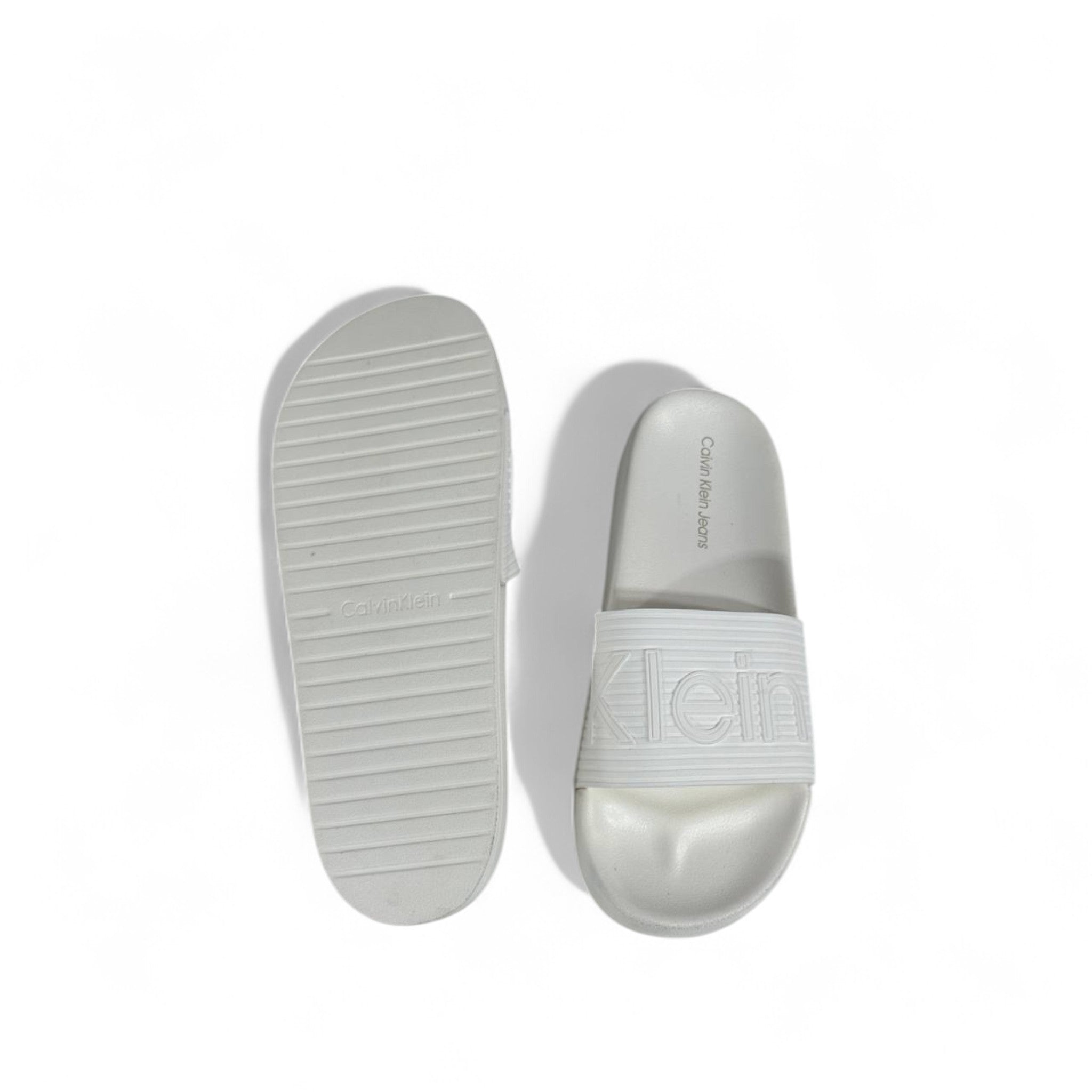 🤍 Calvin Klein All-White Slides – Embossed Logo Luxe Slippers