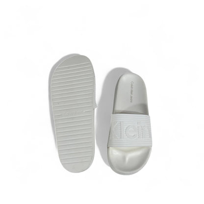 🤍 Calvin Klein All-White Slides – Embossed Logo Luxe Slippers